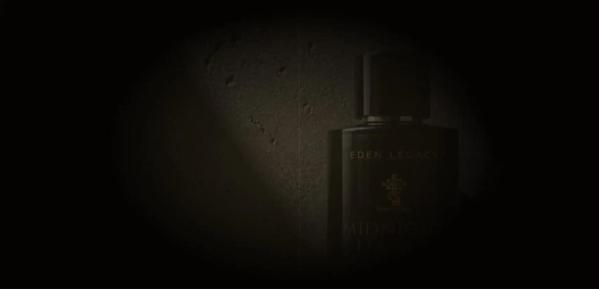 Midnight Legacy Extrait de Parfum by Eden Legacy, a dimly lit bottle against a textured wall.